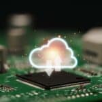 Cloud computing concept showing glowing cloud icon over electronic circuit board, symbolizing FinOps and GreenOps in sustainable IT